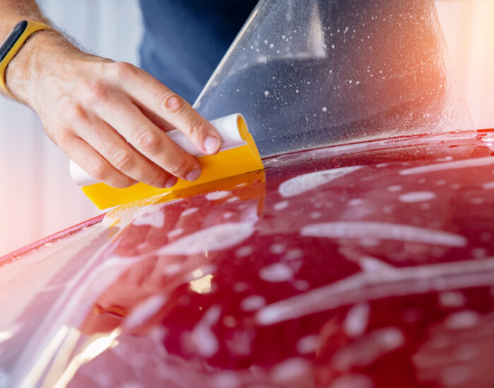 Master man installs vinyl film in risk zone of windshield to protect car body paint